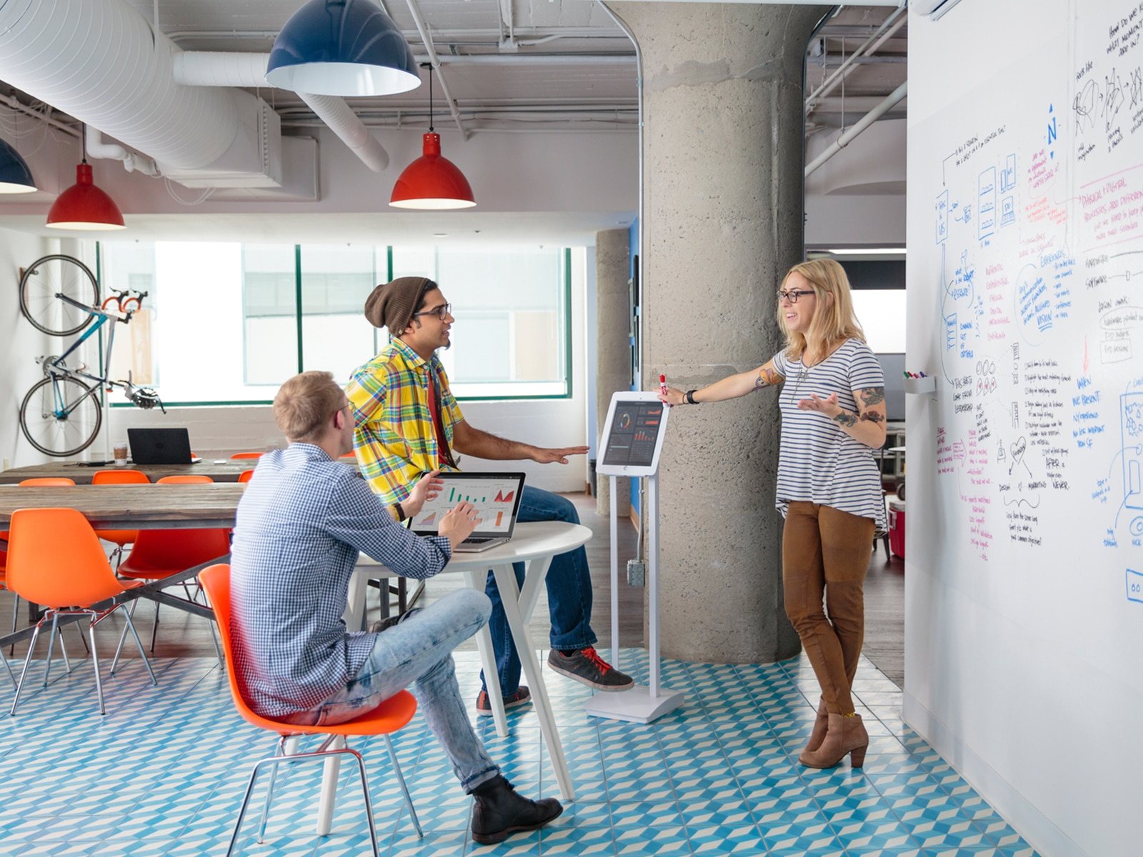 Casual men and woman working together in open modern office.